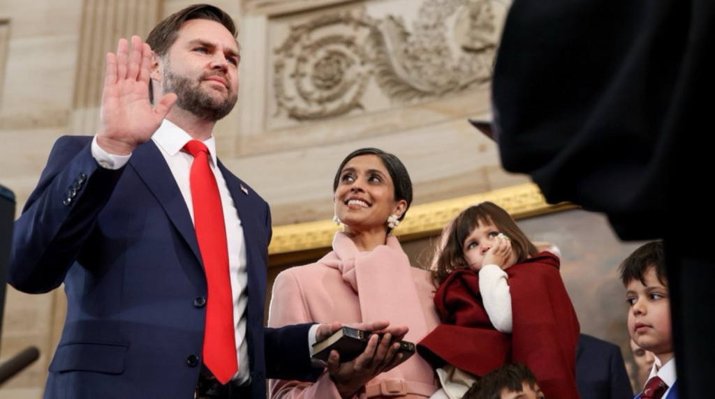 JD Vance raises his right hand to take the oath of office as Vice President, while his wife Usha holds a Bible, and their children look on in the U.S. Capitol.
